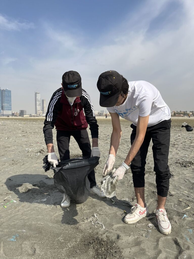 Students clean up clifton beach Karachi sponsored by Roshan Packages Limited